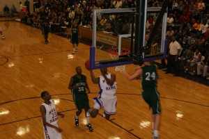 Wall slahes to the rim with former AAU D-One teammate Mason Plumlee trying to alter his shot