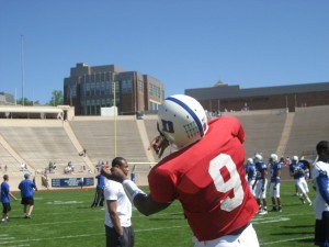 Lewis warms up on the practice field